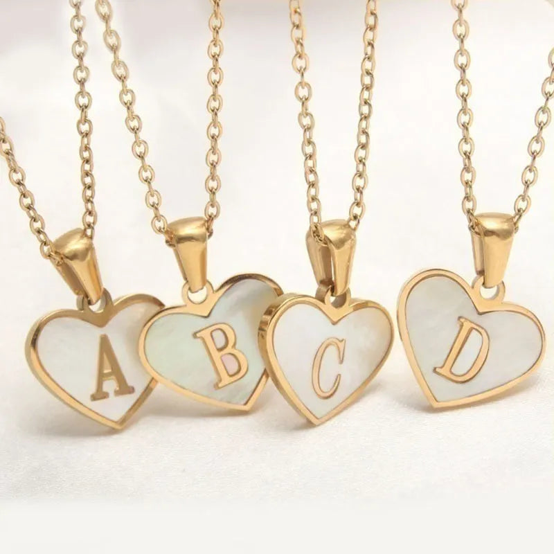 Gold plated heart-shaped personalised necklace with white shell charm on an adjustable chain.