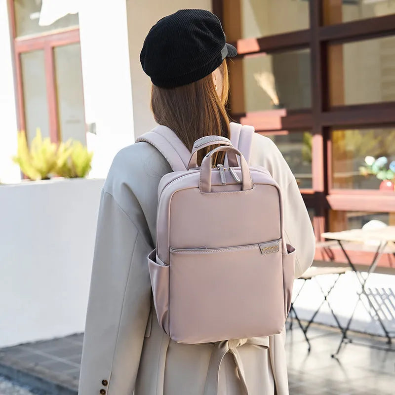 Simple canvas women's travel backpack in apricot colour with multiple compartments and sandwich pocket