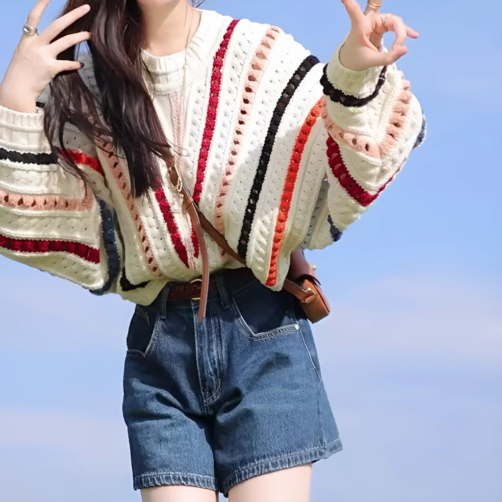 Colourful rainbow striped loose knit sweater with batwing sleeves and a round neck.