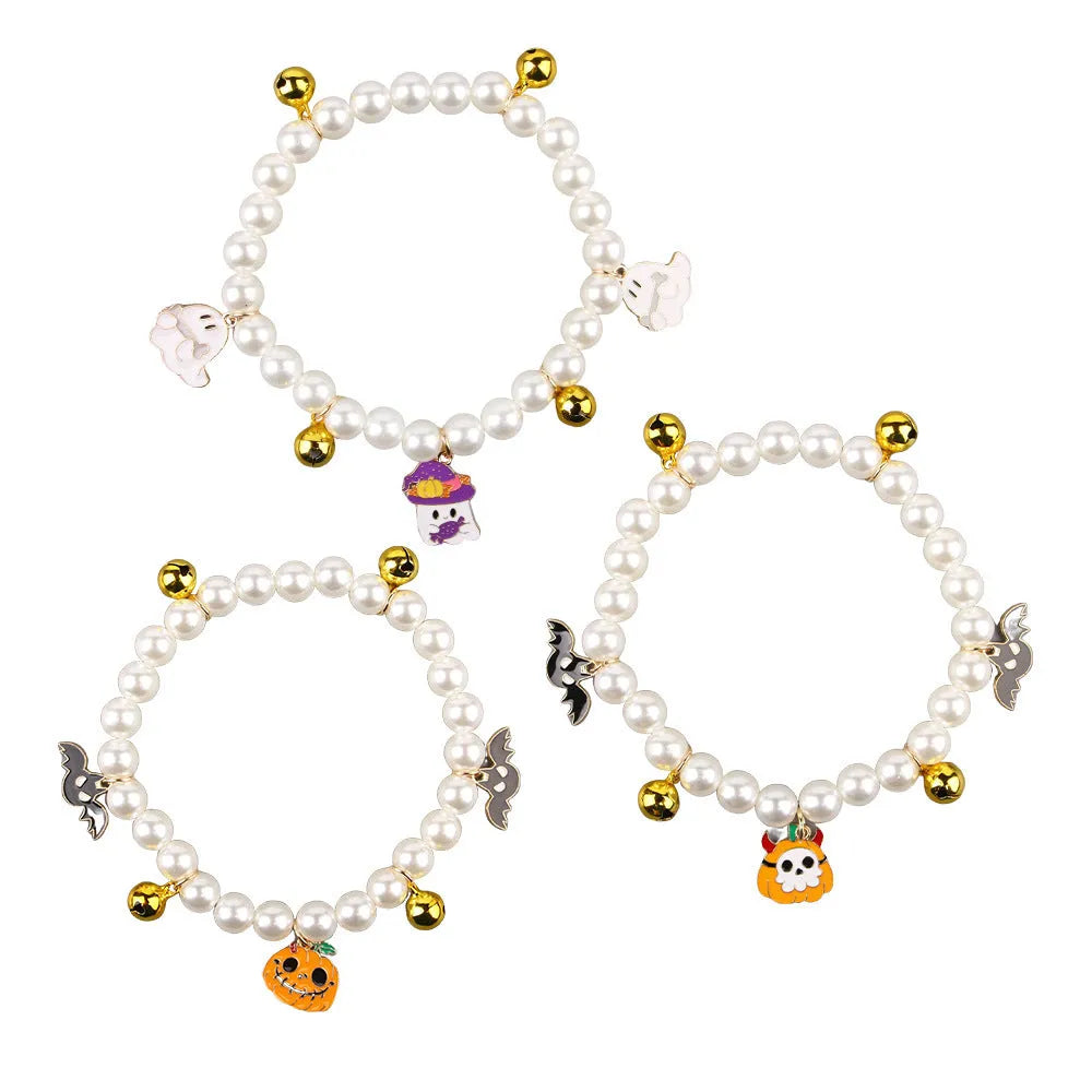 Adjustable simulated pearl necklace cat collar with a Halloween pumpkin charm in purple ghost, skull, or smile designs.