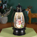 Crystal ball Christmas lamp with illuminated snowman figure inside, on a wooden table.