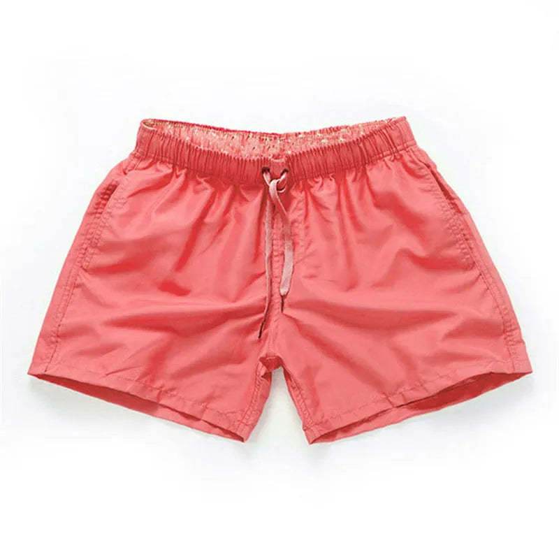 Men's polyester beach shorts with straight leg opening in multiple colours including black, white, and fluorescent yellow