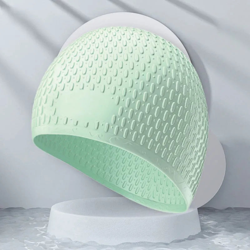 Silicone adult swimming cap with water drop texture in solid colour options on white background.