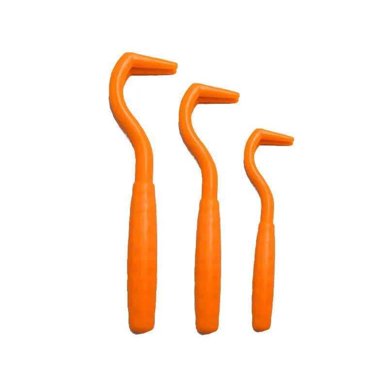 Set of three coloured tick hook removers for dogs on a white background.