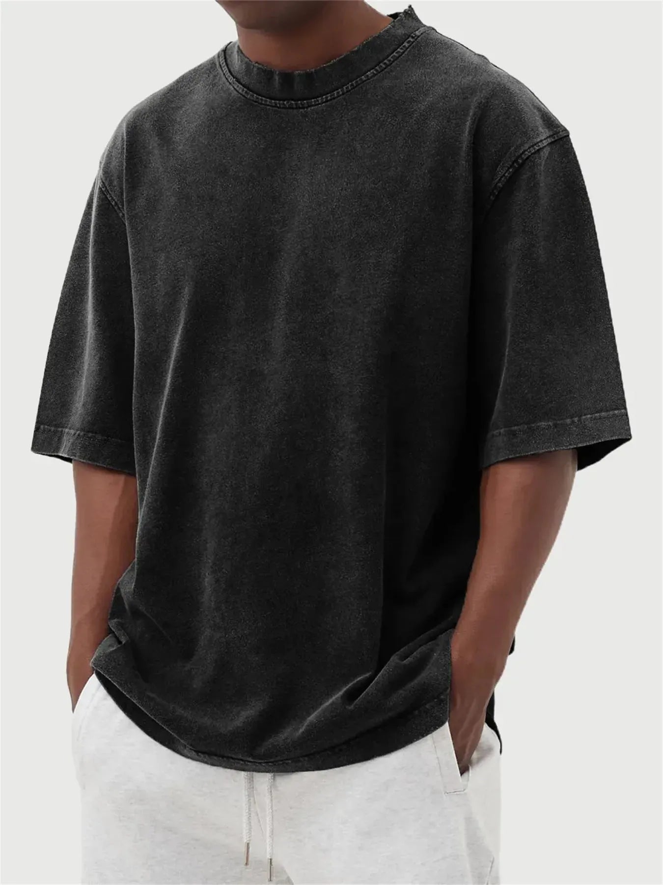 Men's loose-fit stone-washed t-shirt in army green showing distressed texture and pullover style.