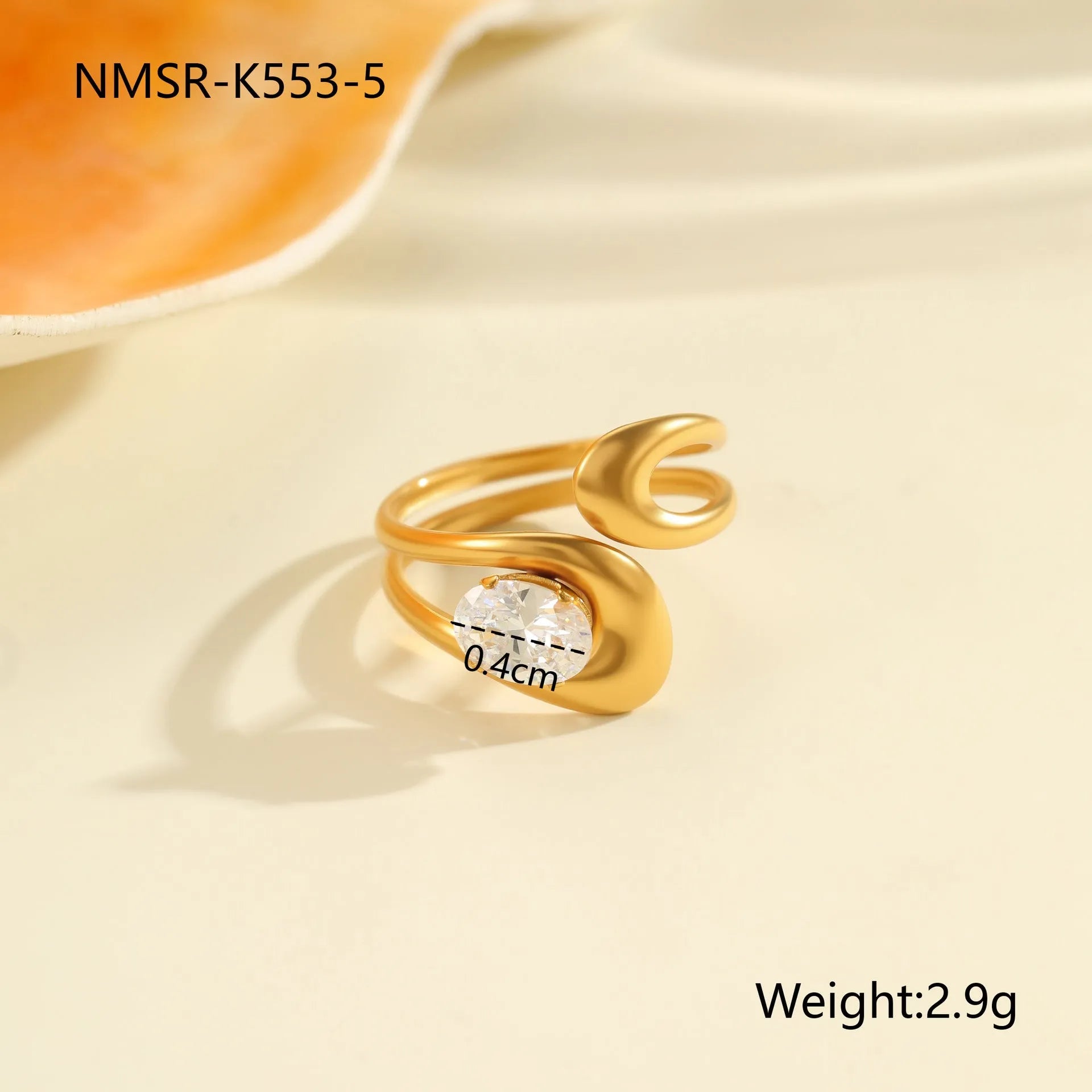 Women's geometric zircon ring with adjustable open mouth design on a hand.