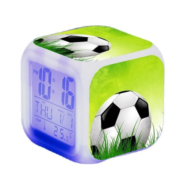 Square plastic alarm clock with football pattern design showing four alarm settings and USB charging port
