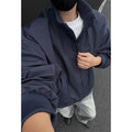 Men's cleanfit short jacket in solid colour polyester with side seam pockets, black colour option