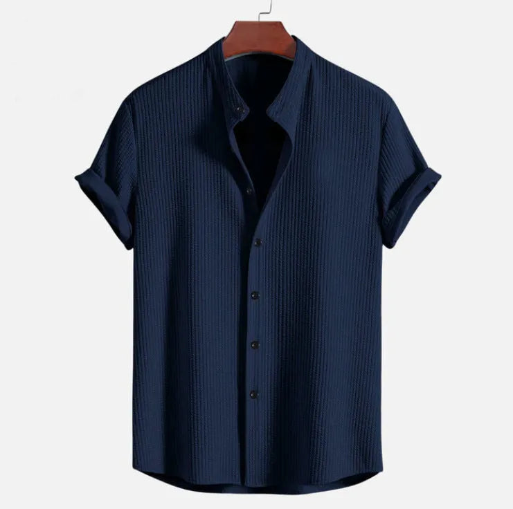 Men's loose fit short sleeve polyester summer shirt on a hanger, shown in a light blue colour.