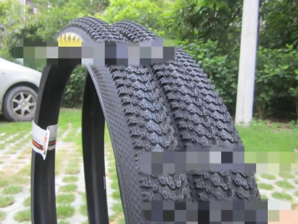 Ultralight puncture-proof mountain bike tyre shown in black with aggressive tread pattern.