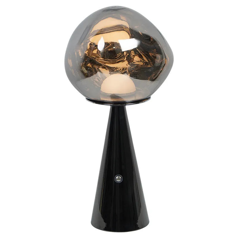 Volcanic lava mini table lamp with metal holder in gold finish, USB magnetic charging, on a bedside table