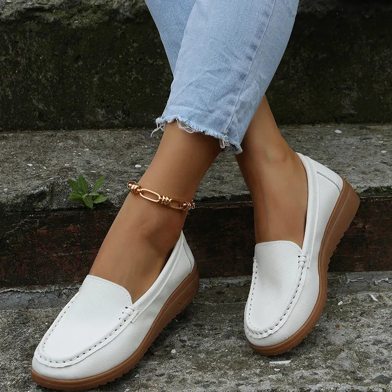 Women's flat slip-on loafers in PU leather, showing round toe and available colour options