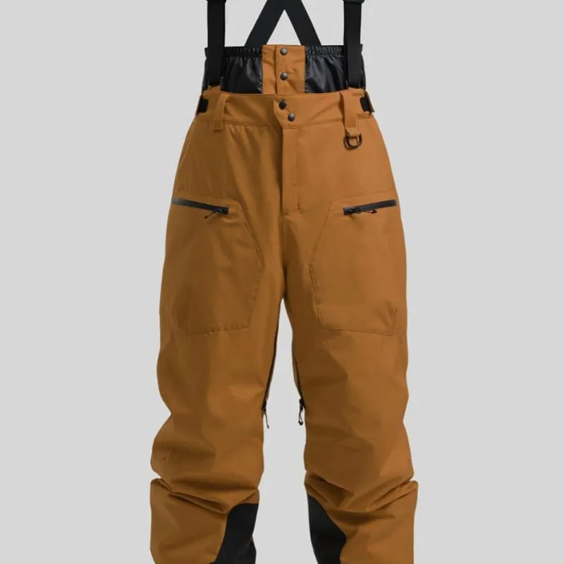 Man wearing black waterproof ski trousers with an adjustable strap on a snowy slope.