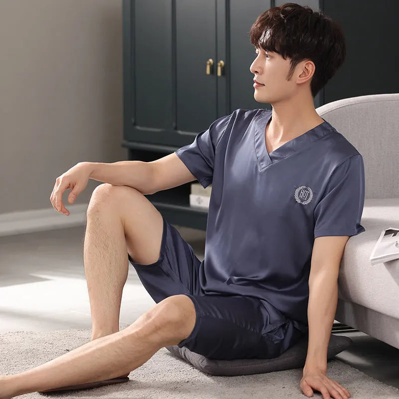 Man's ice silk short-sleeve pyjama shirt and shorts set in a loose, comfortable fit on a hanger