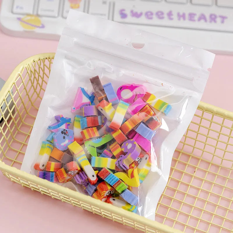 50 small colourful cartoon erasers in a pearlescent bag showing fruit, animal, cake, and Halloween themes.
