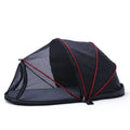 Black half mesh cat folding tent folded for storage with mesh ventilation panels visible