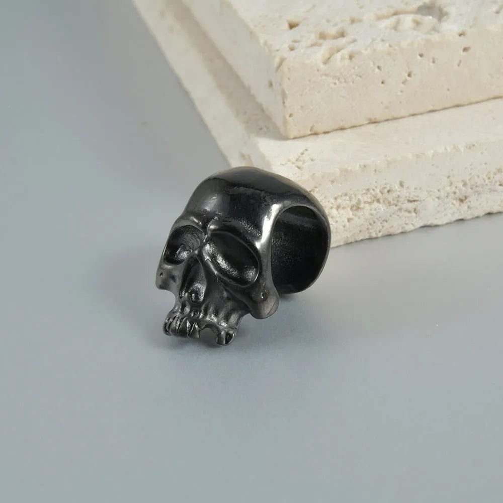 Stainless steel geometric earrings with hollow skull and Buddha head design in electroplated colour options.
