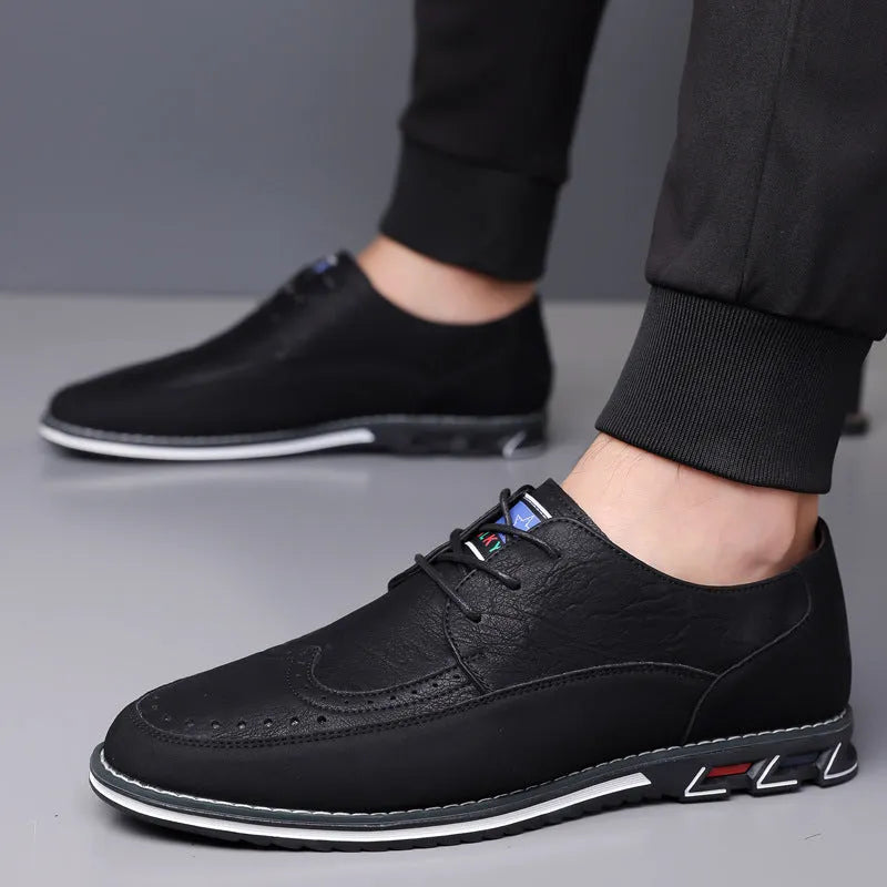 Men's leather slip-on shoes in black, grey, khaki and orange colours with rubber soles and low-top design