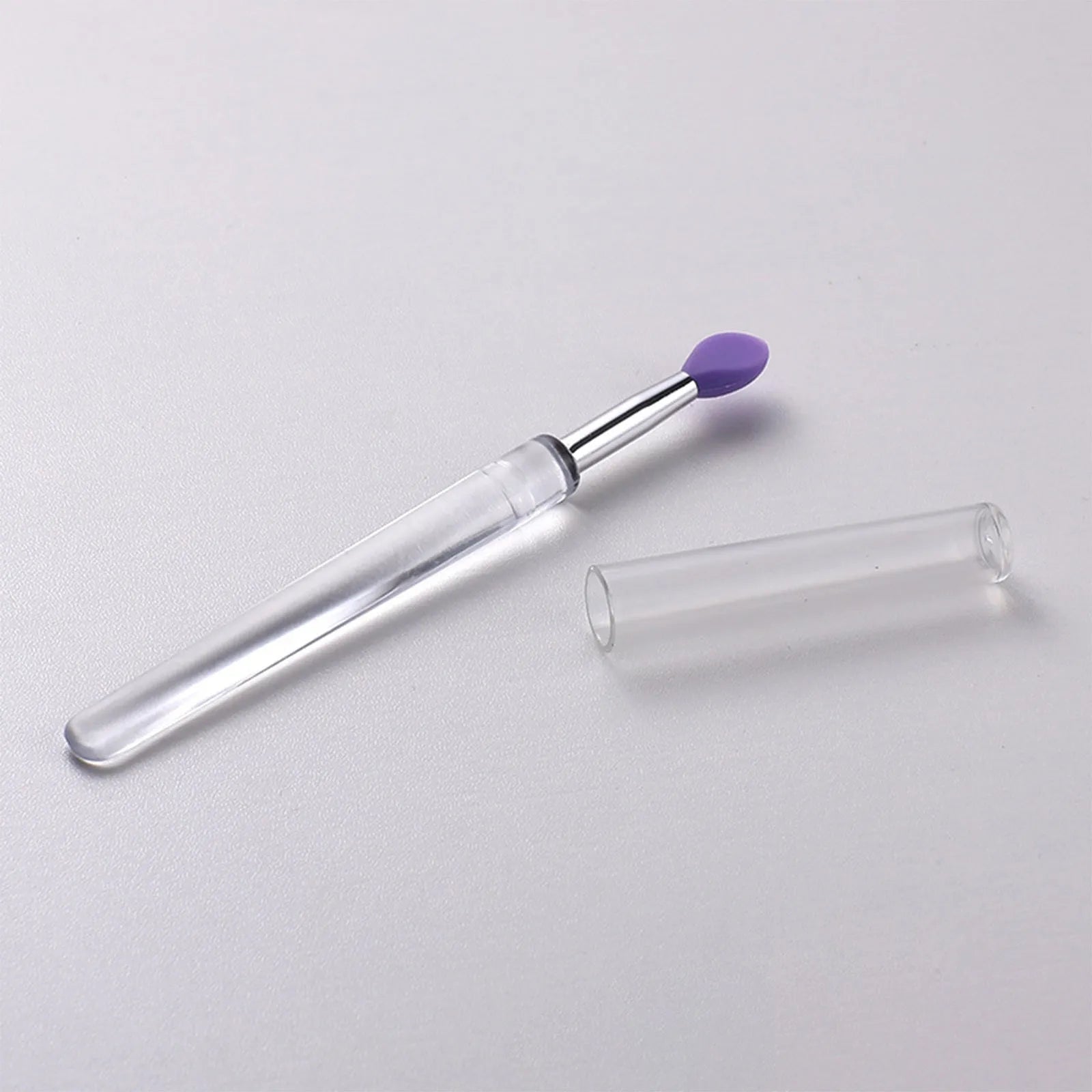 Set of coloured silicone lip brushes with protective caps for applying lipstick and lip gloss.