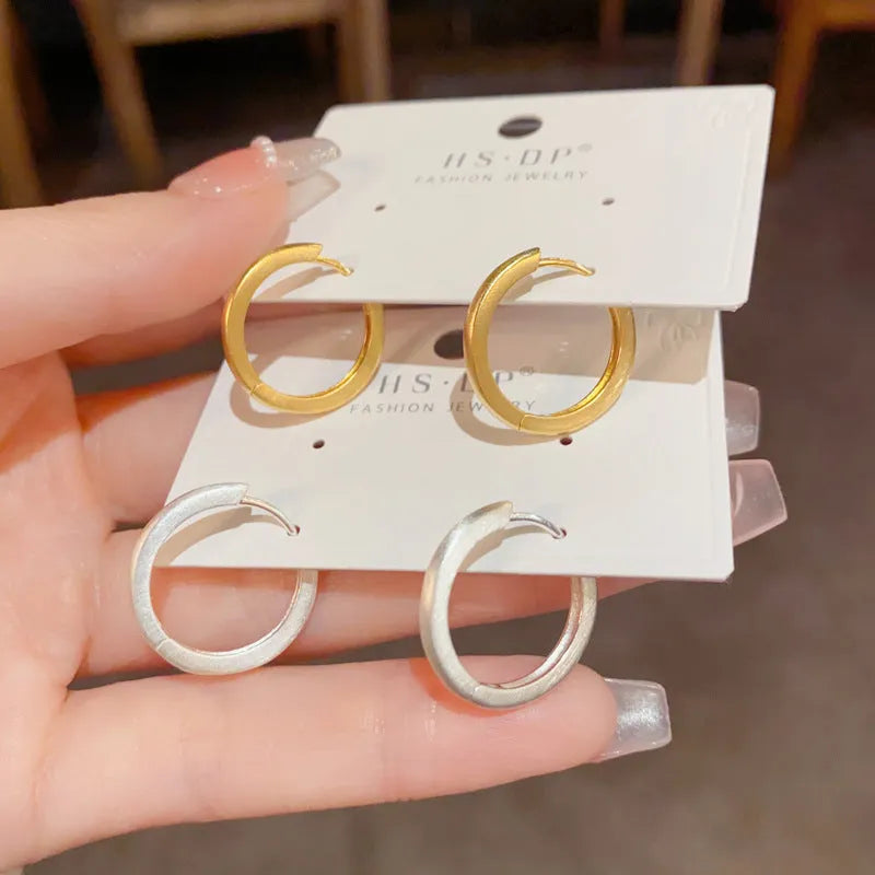 Geometric gold or silver-plated ear clip with round eyelet detail for women