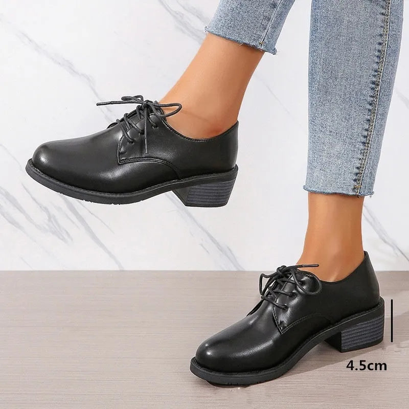Black women's low-top work shoes with a chunky mid-heel and rounded toe.