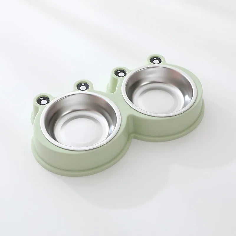 Stainless steel frog-shaped double bowl for pet food and water in blue, green, or pink.