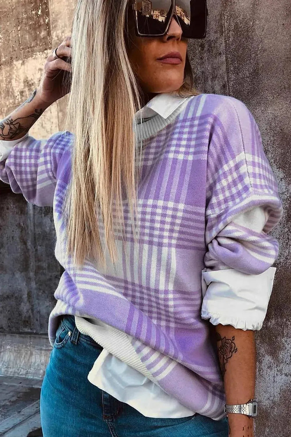Lilac plaid print loose fit long sleeve sweater with ribbed cuffs on a hanger.