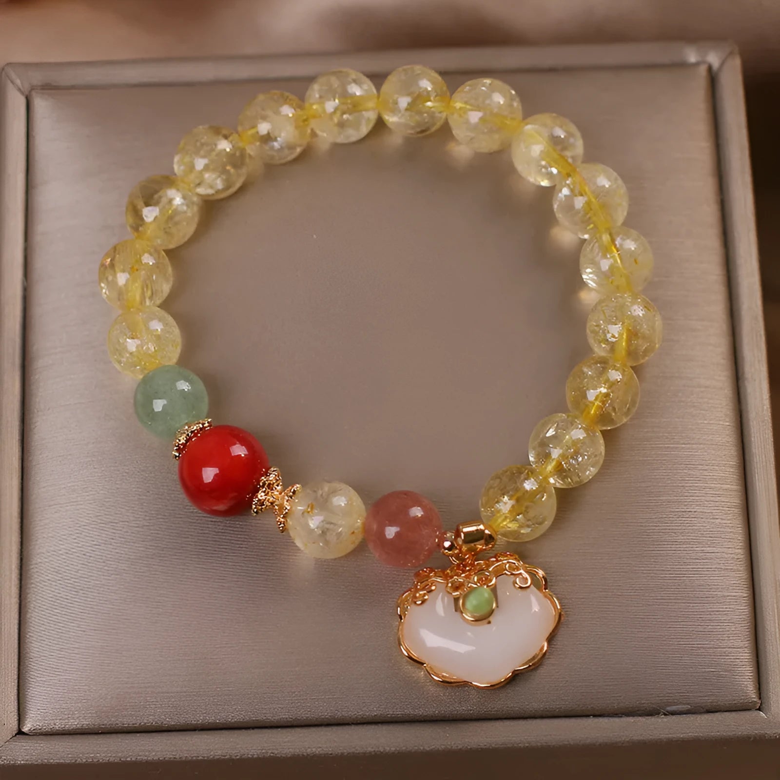 Women's yellow hair crystal jade Ruyi pendant on an alloy bracelet.
