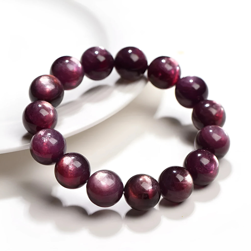 Natural purple lepidolite crystal bracelet with round polished beads on a wrist.