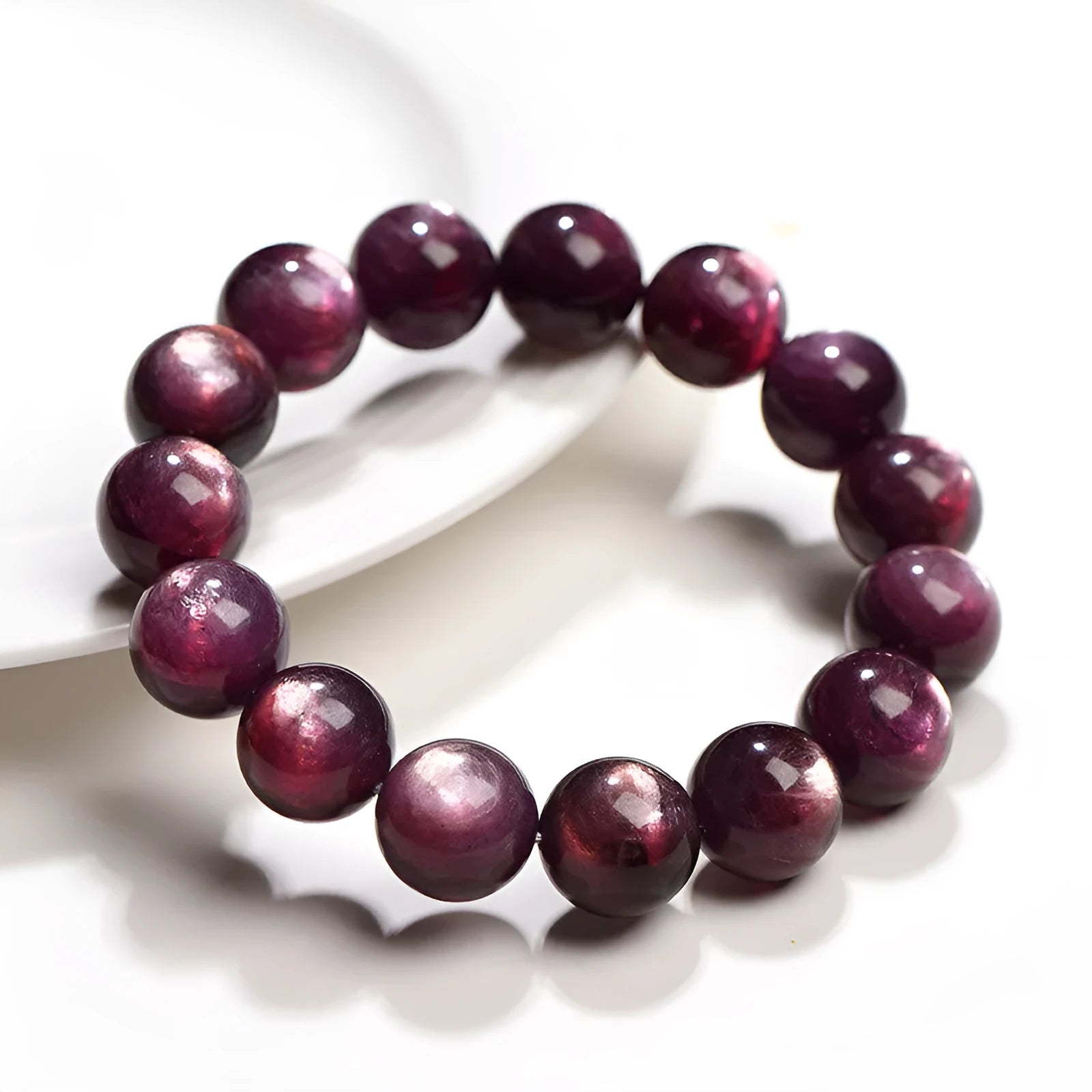 Natural purple lepidolite crystal bracelet with round polished beads on a wrist.