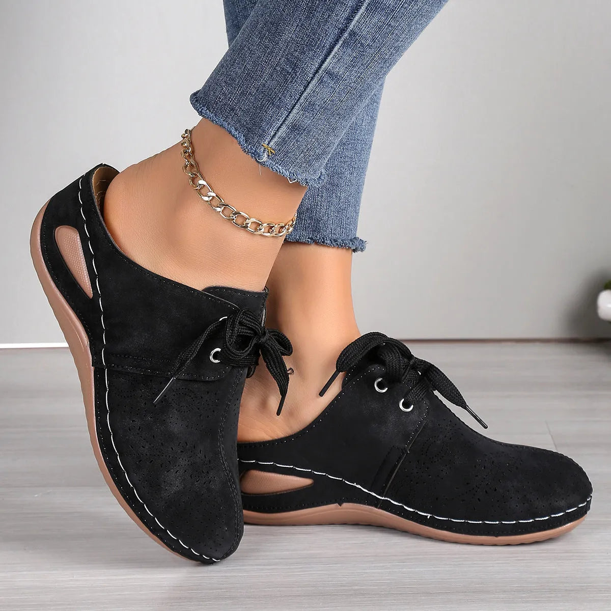 Women's black suede lace-up wedge slippers with a baotou toe and hollow out heel on a rubber sole.