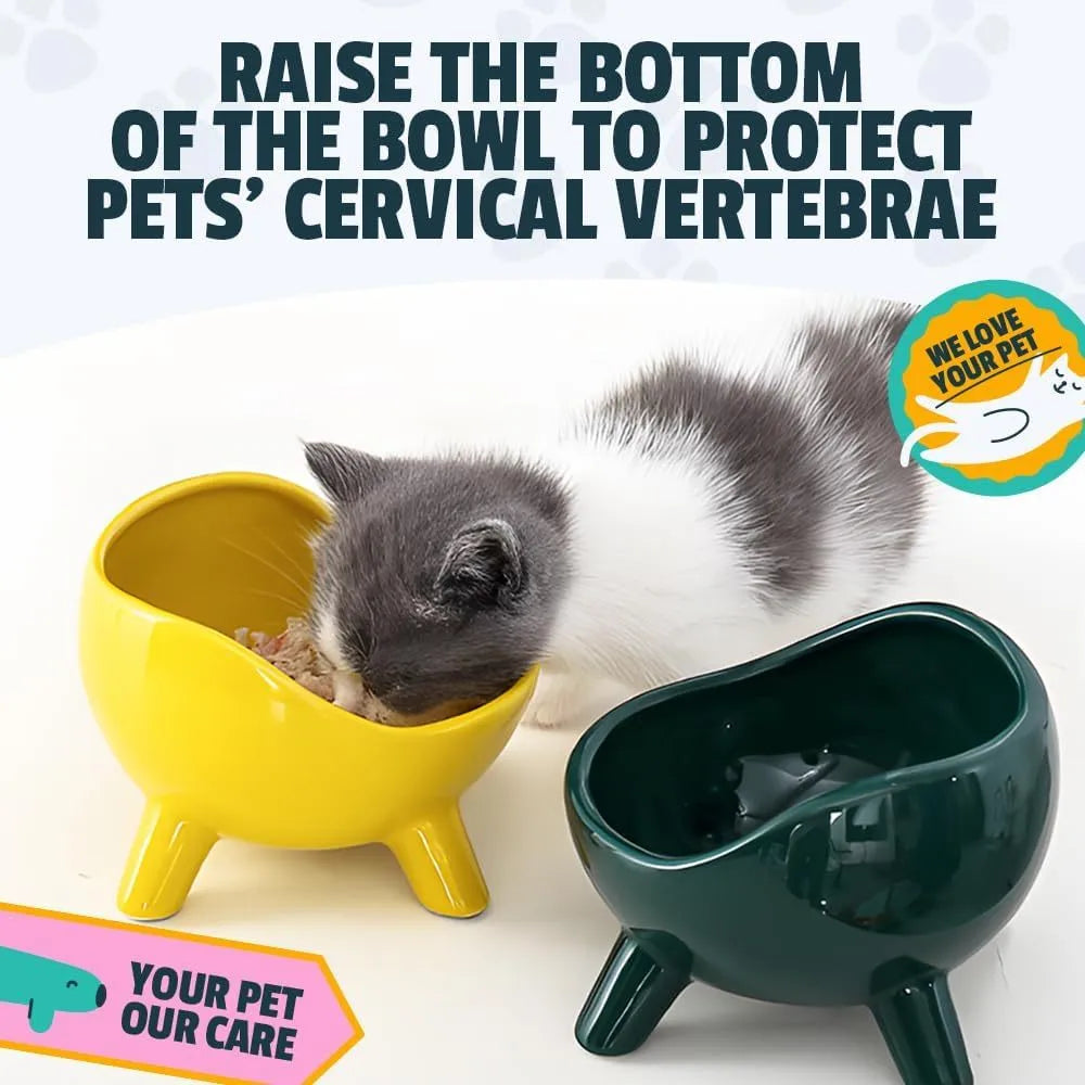 Green ceramic cat food bowl with four-leg stability base on wooden floor
