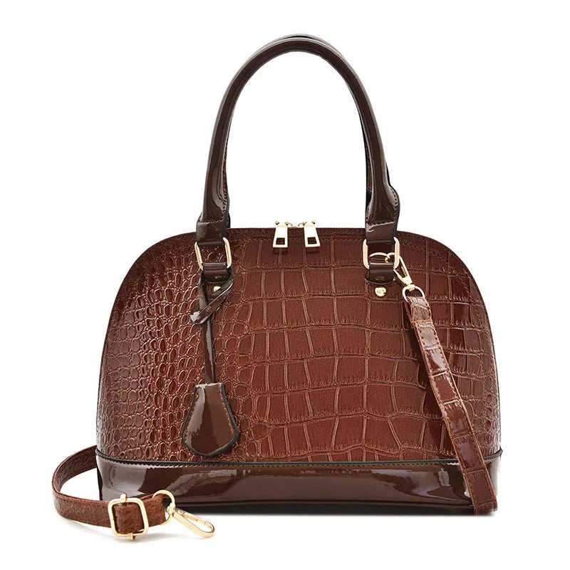 Shiny PU crossbody shoulder bag in shell shape showing black, red, and brown colour options