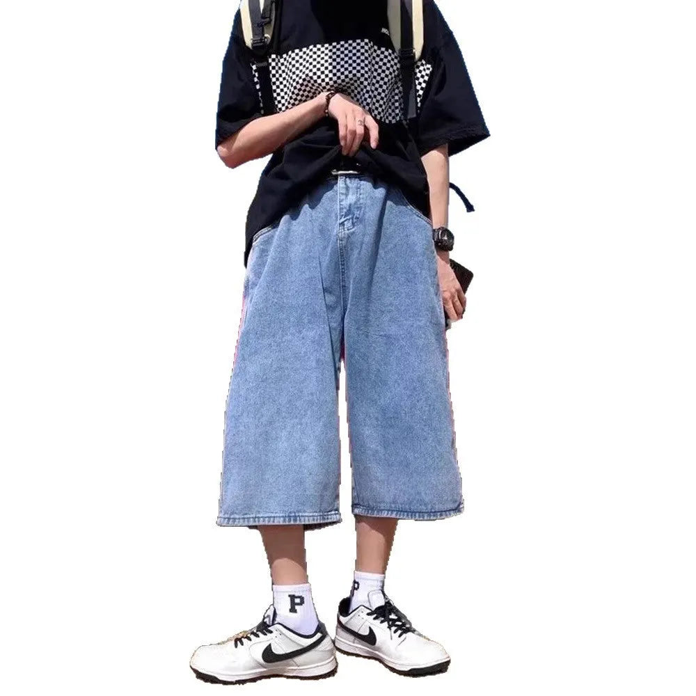 Man wearing blue washed denim pirate-style shorts with cropped length and high waist.