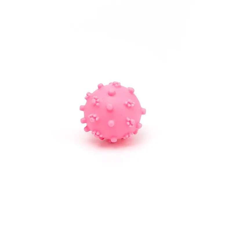 Bright blue, green, pink and yellow spiky dog balls with paw print dimples for small breed chewing and fetch.