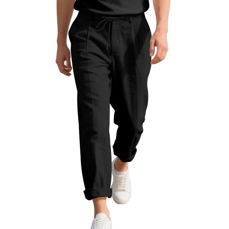 Men's loose-fit straight-leg linen trousers in light khaki colour with a drawstring waist.