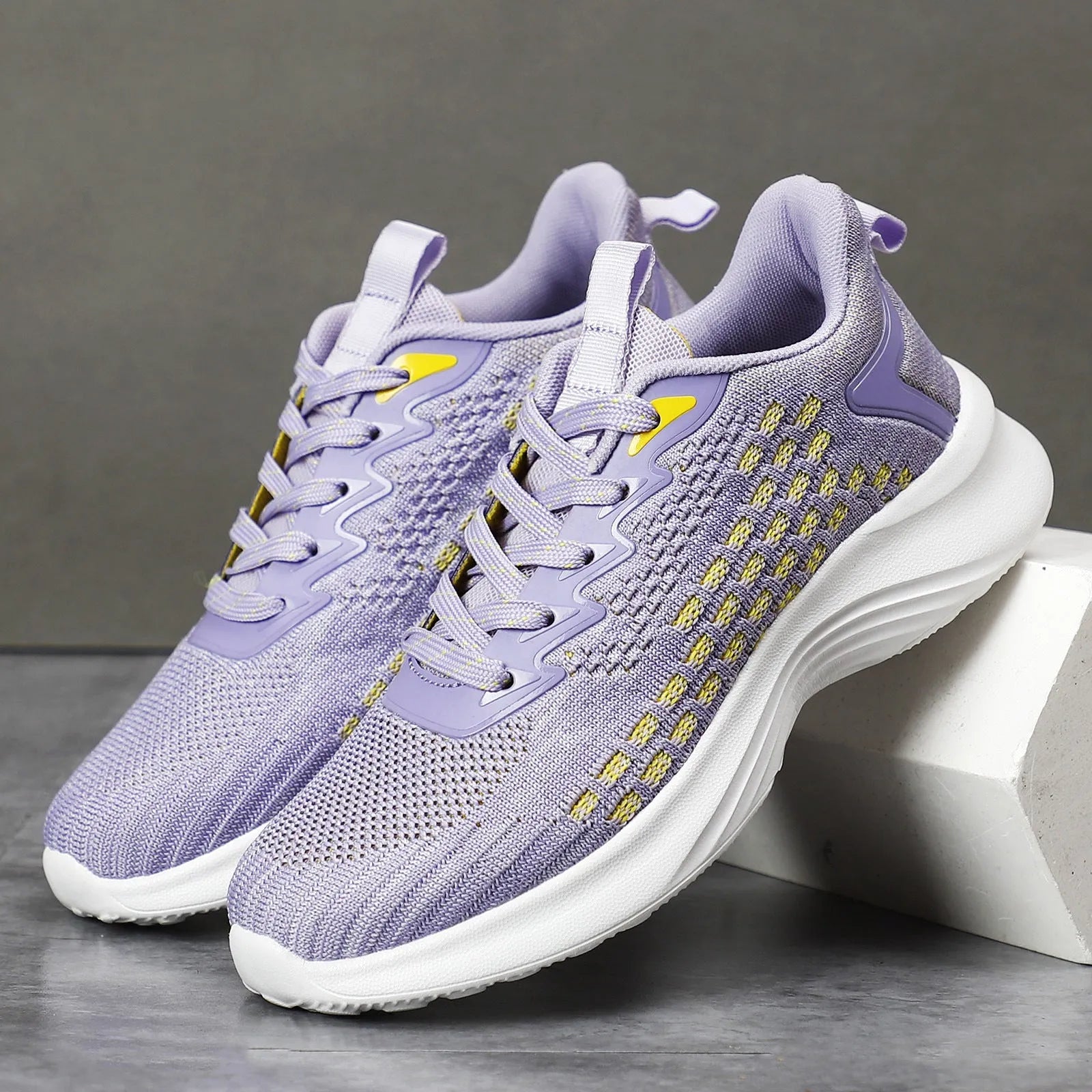 Women's lavender purple Flyknit running shoes with striped pattern and mesh design for sports
