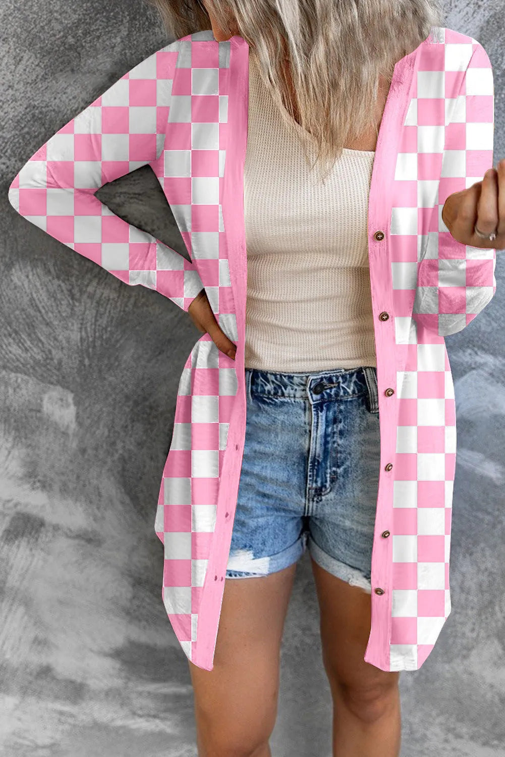 Long grey plaid knitted cardigan coat on a model, showing loose fit and regular sleeves.