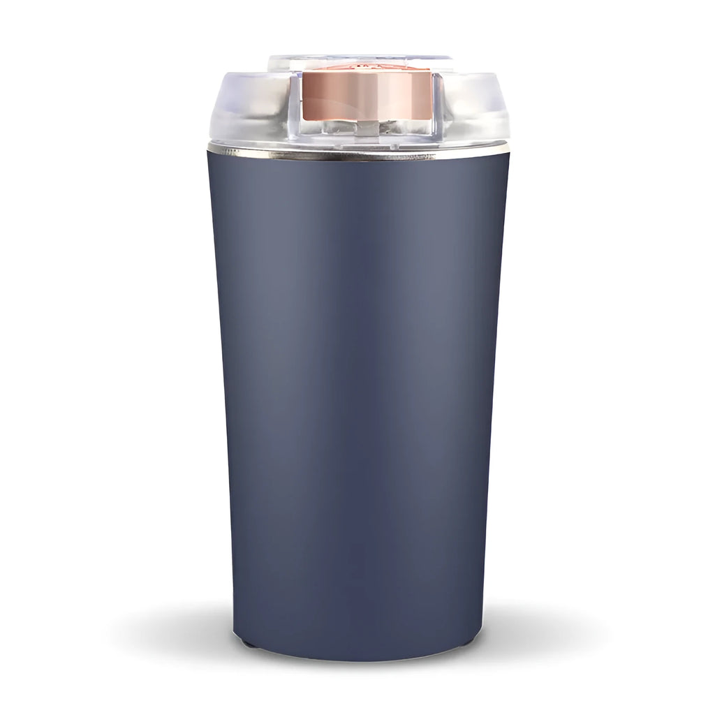 Blue mini electric grain and spice grinder with stainless steel blade on a kitchen worktop