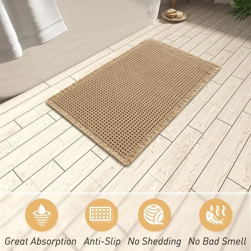Square checkered-pattern non-slip bathroom carpet in a neutral colour on tiled floor.