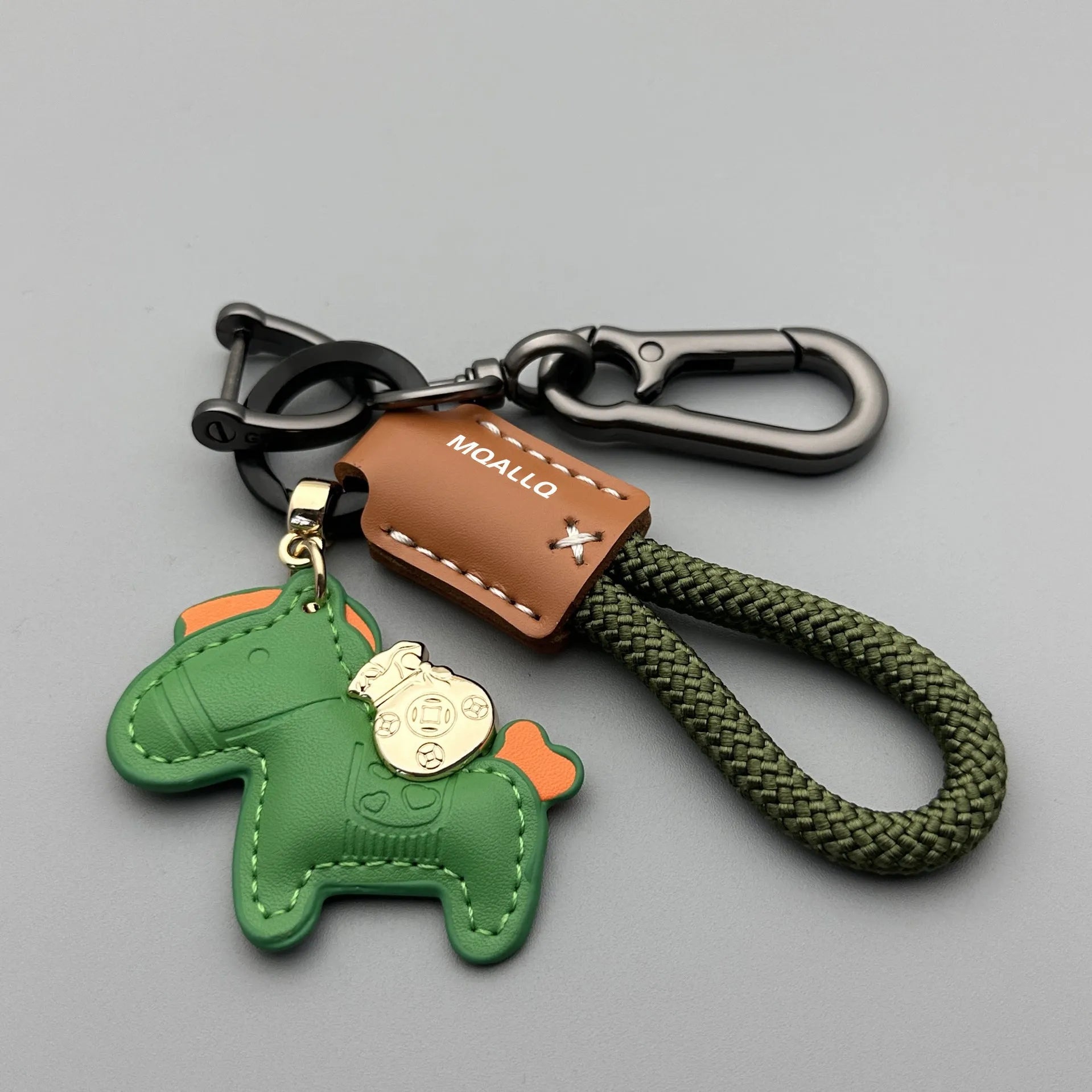 Handmade brown cowhide leather car key ring pendant with a zinc alloy belt buckle and green flanelle rope.
