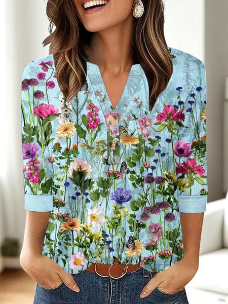 Woman wearing a loose V-neck T-shirt with a bold 3D pattern print in casual style.