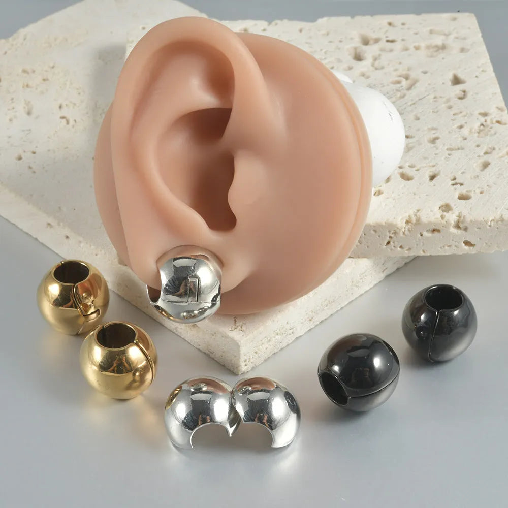 Stainless steel geometric earrings with hollow skull and Buddha head design in electroplated colour options.