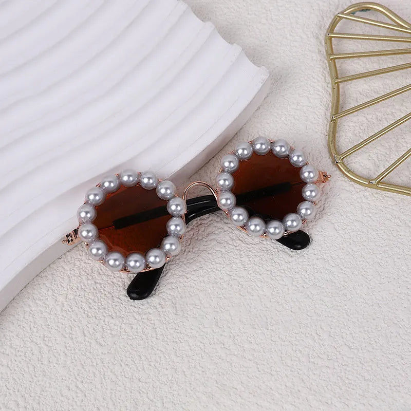 Pearl-rimmed round sunglasses for cats and dogs in multiple colours as costume accessories