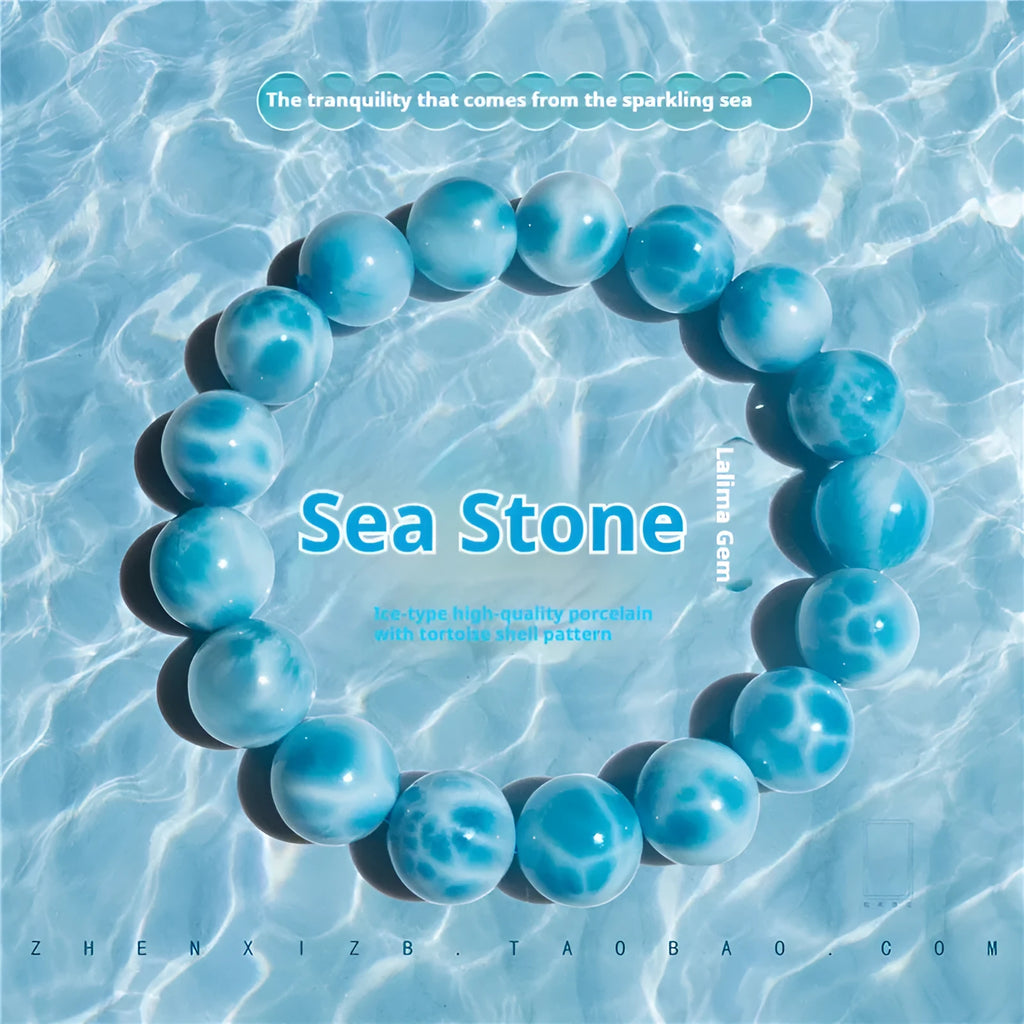 Blue natural Bodhi seed and crystal sea-pattern stone bracelet with a single pearl accent on a wrist.