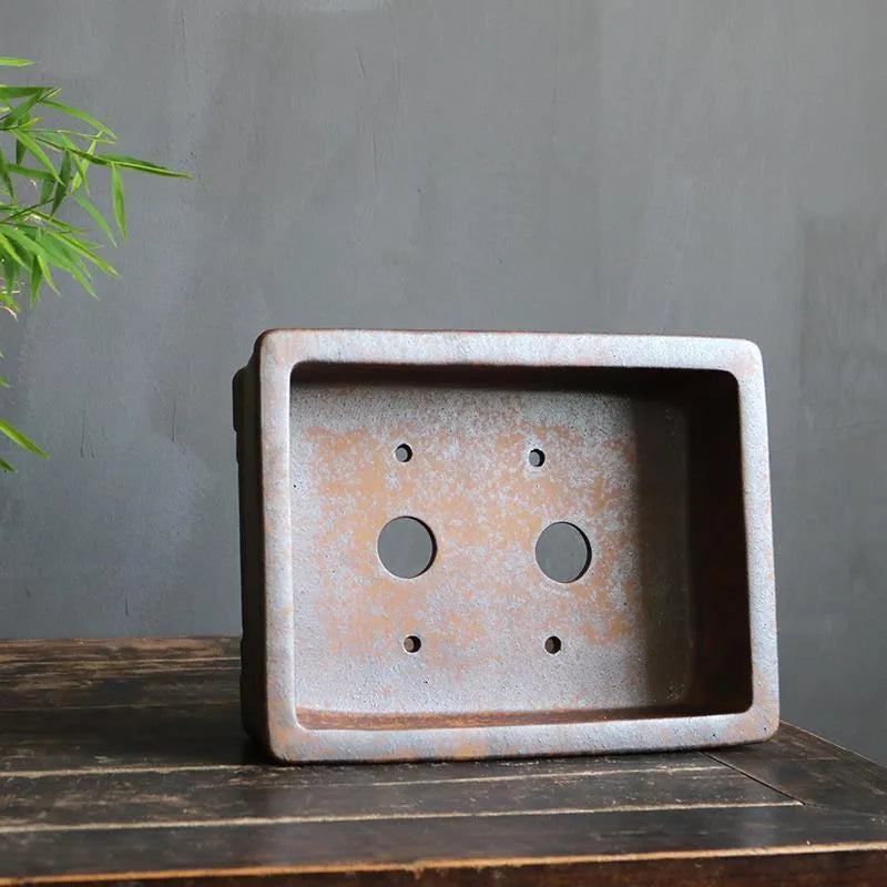 Purple sand rectangular bonsai planter with five-line basin design on wooden surface
