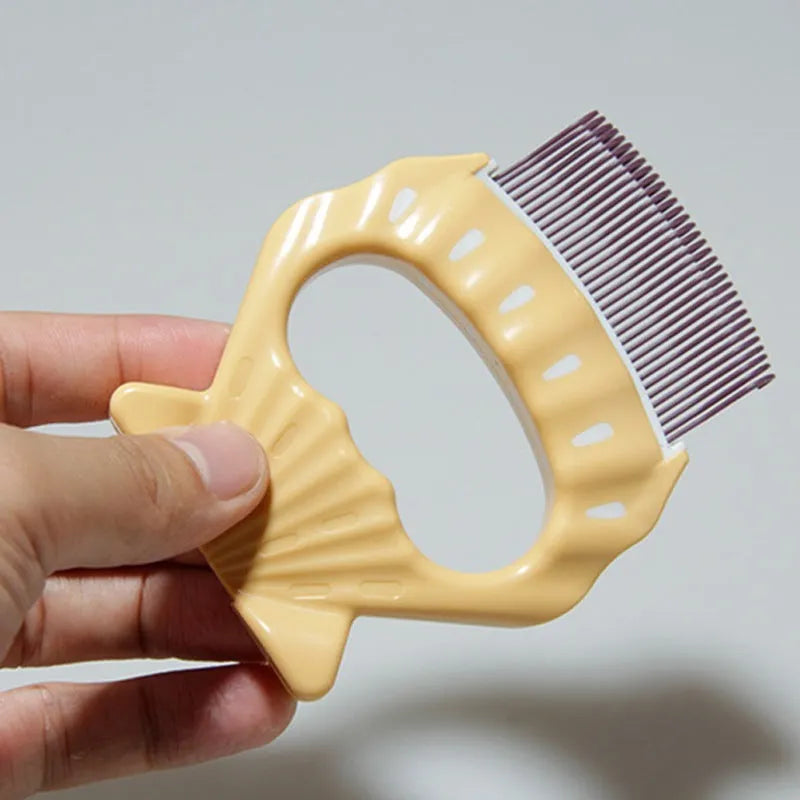 Shell-shaped plastic pet grooming comb with bent wire bristles and anti-slip handle in assorted colours.