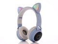 Cartoon-style wireless Bluetooth headset with cat ears, shown in a choice of five colours including green and pink.