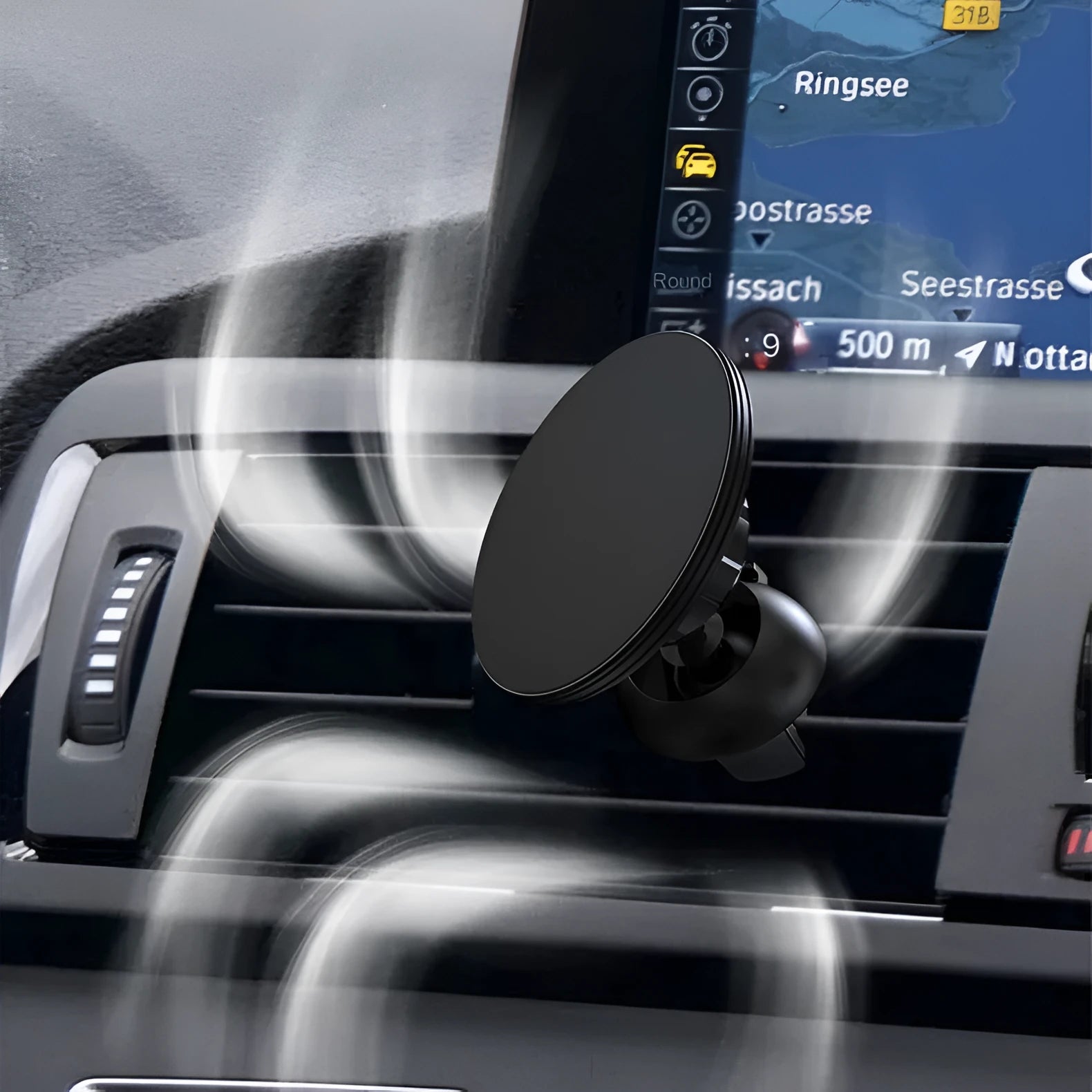 Black aluminium alloy magnetic suction car phone holder mounted on a car air vent.