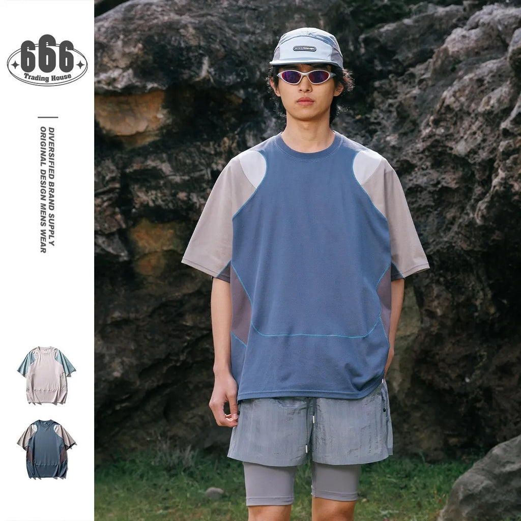 Man wearing a loose fit patchwork t-shirt in a solid colour with short raglan sleeves.